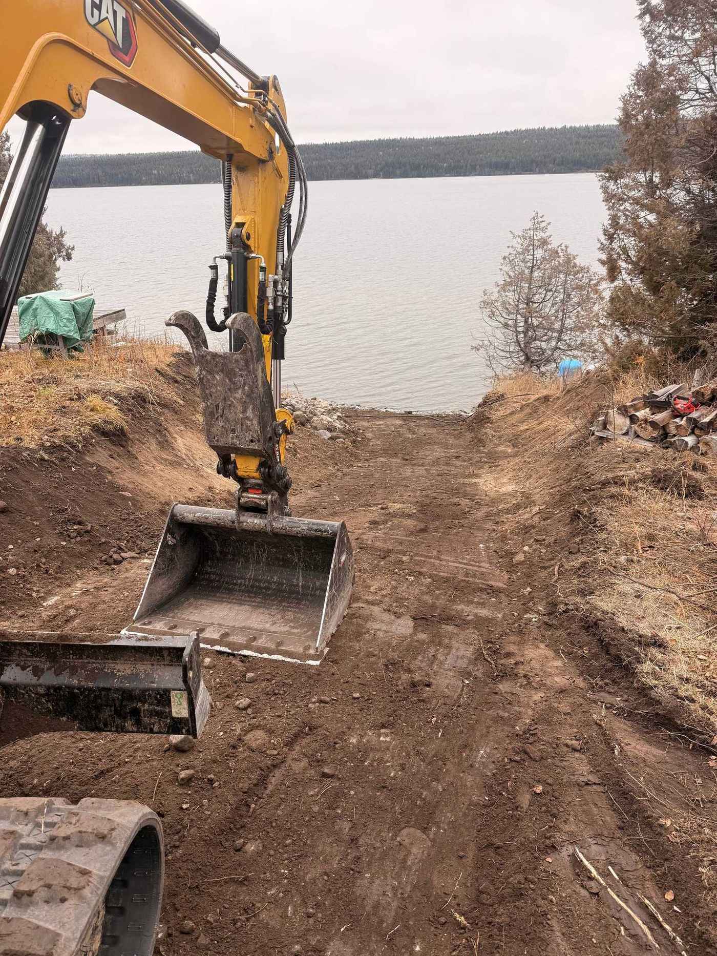 CAT 305 excavator grading a lakefront path in the Cariboo
