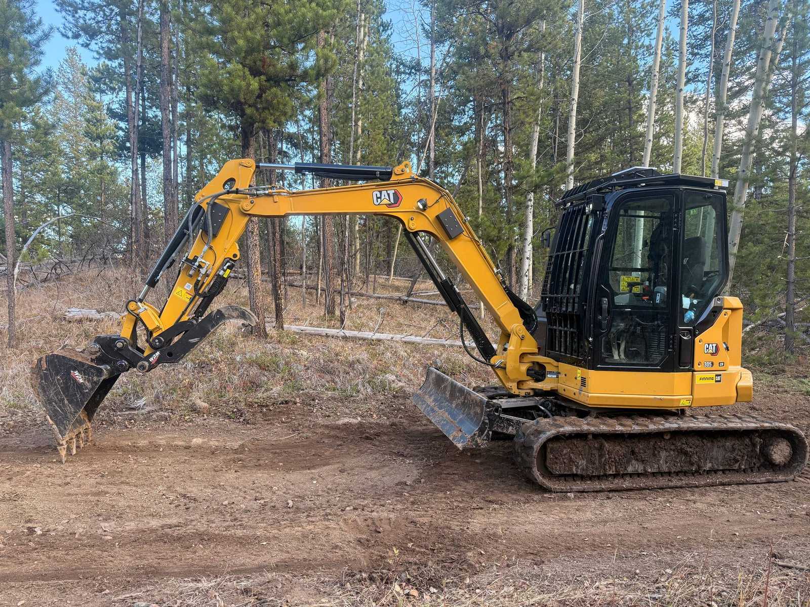CAT 305 Next Gen excavator on a land clearing job site